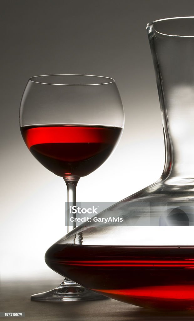 carafe of red wine with wineglass wine glass and one half of a decorative wine carafe. Image is a study in color and design,reducing the subject to it's basic elements.http://www.garyalvis.com/images/foodDrink.jpg Decanter Stock Photo