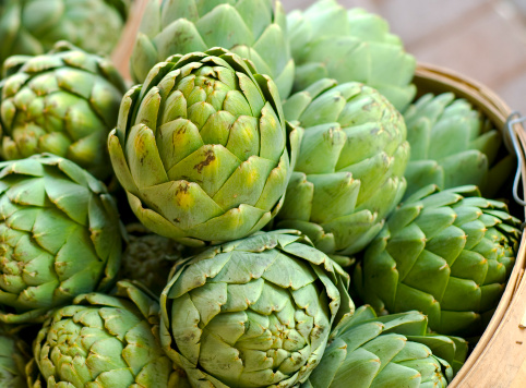 Assorted organic artichokes sold on a marketplace in Genoa, Liguria, Italy