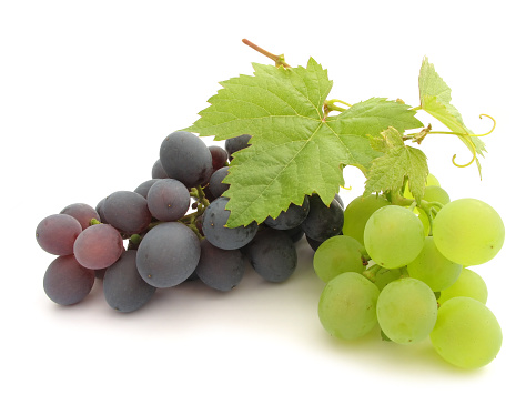 Fresh green grapes with leaves. Isolated on white background