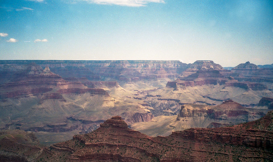 35mm photograph of an overview vista of the Grand Canyon National Park in Arizona USA, with blue sky