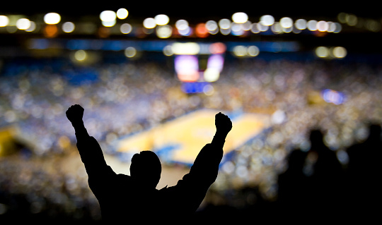Fan pumping his fists at a college basketball game. PLEASE SEE UPDATED, HI-RES VERSION: