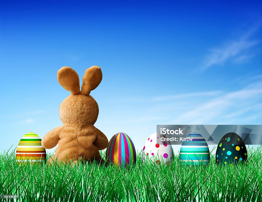 Easter Eggs and Bunny Handmade Bunny sitting along with decorated Easter Eggs. Easter Bunny Stock Photo