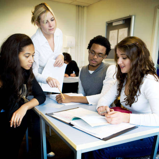 istock further education: teacher and college students working together in class 157316751