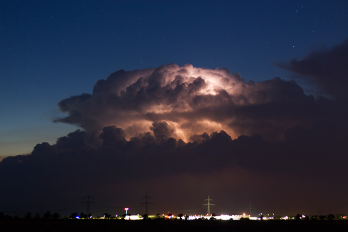 Lightning strikes down from a dramatic looking thunderstorm over the countryside of Transylvania in eastern Europe.