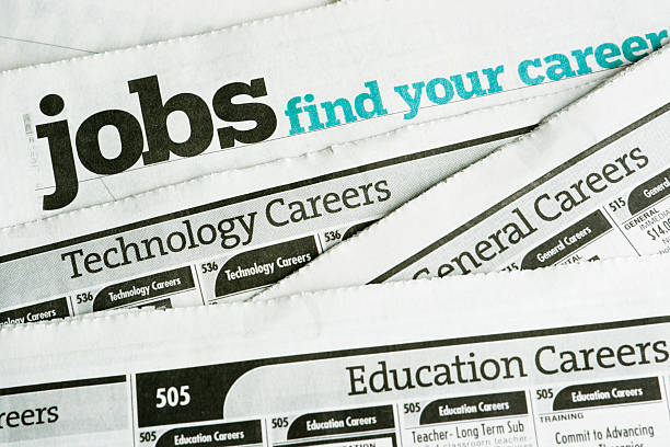 Job Search and Employment, Occupation Opportunity Classified Ad Newspaper Page Newspaper job listing pages, stacked to illustrate job search and employment opportunities and the job hunting process of looking for careers and occupations in the classified ad section of printed papers. For concepts of unemployment, employment issues, recession, economic depression, recovery, job seeking and discovery. Horizontal image with no people. job search stock pictures, royalty-free photos & images