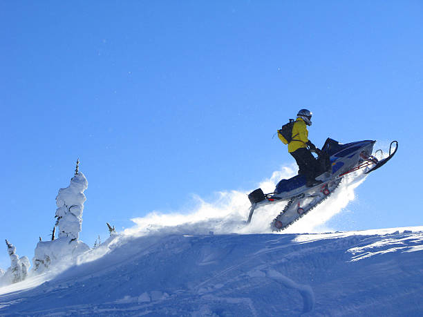 istock Man on snowmobile jumping on hilltop 157317149