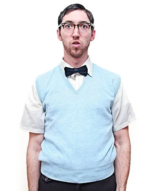 Lonely looking nerd guy isolated on a white background. Vertical with copy space.