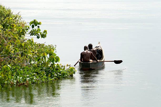 Fishing Two men in a boat, fishing at Lake Victoria. lake victoria stock pictures, royalty-free photos & images