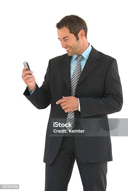 Hombre De Negocios Mirando A Un Teléfono Móvil Foto de stock y más banco de imágenes de Fondo blanco - Fondo blanco, Hombres, 30-39 años