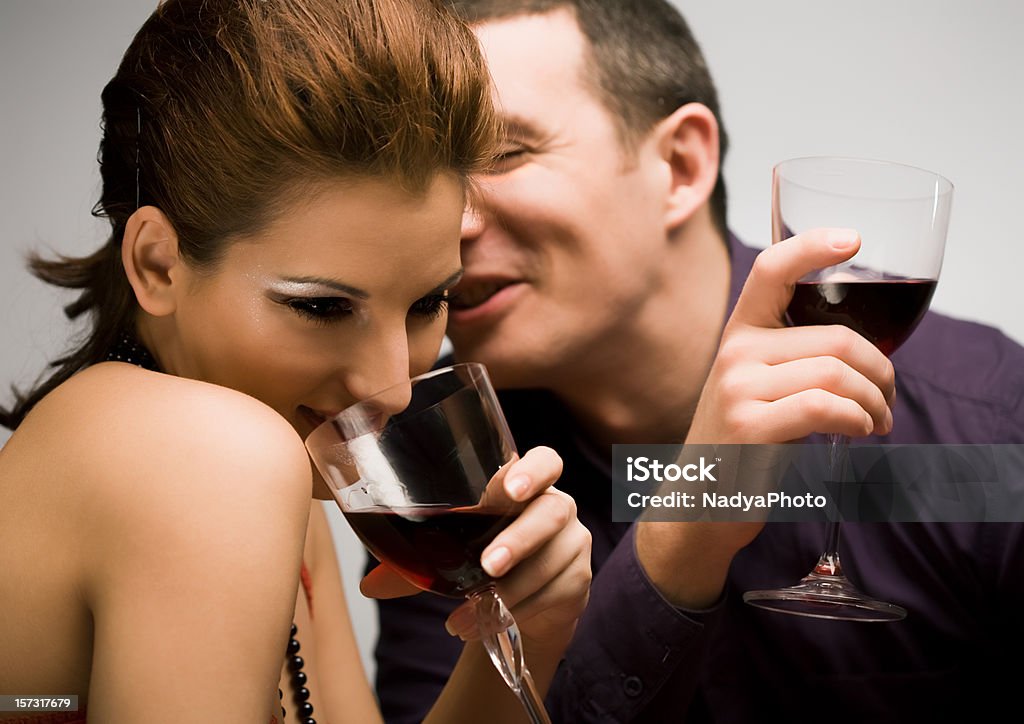 Couple Having a Dinner Young couple drinking wine and having fun Adult Stock Photo