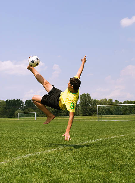 Male soccer player doing a bicycle kick stock photo