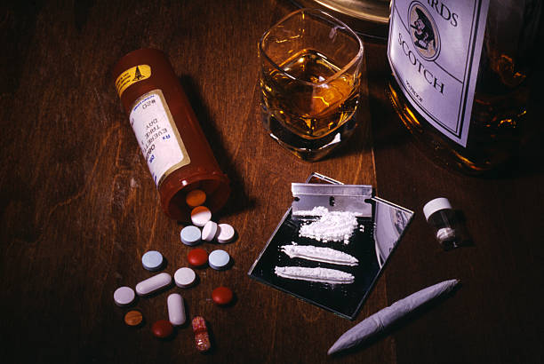 Drugs and Alcohol Addiction Tableau of drugs- pills, coke, marijuana, and alcohol. cocaine photos stock pictures, royalty-free photos & images