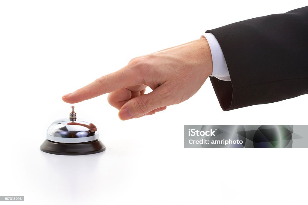 finger of businessman ringing reception bell finger ringing reception bell shot on white background Bell Stock Photo