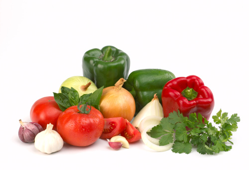 Healthy food cooking ingredients background with fresh vegetables, herbs, spices and olive oil on marble table top view