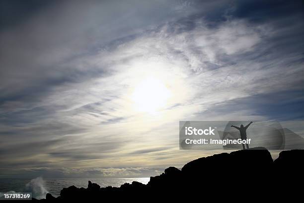 Woman Standing By The Sea With Arms Raised Stock Photo - Download Image Now - Arms Raised, Horizon, One Woman Only