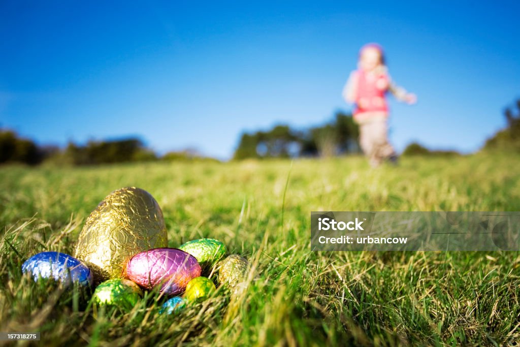 Easter eggs Young girl running towards Easter eggs. Low depth of field, focus in foreground. Easter Egg Hunt Stock Photo Easter eggs Young girl running towards Easter eggs. Low depth of field, focus in foreground. Easter Egg Hunt Stock Photo