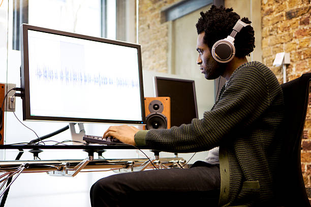 modern workplace: sound editor at his desk editing wave forms  mixing photos stock pictures, royalty-free photos & images