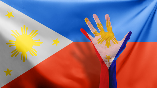 A human hand with a Philippine flag color. Philippines Independence Day concept