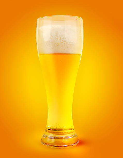 istock glass of light beer on orange yellow background 157324904