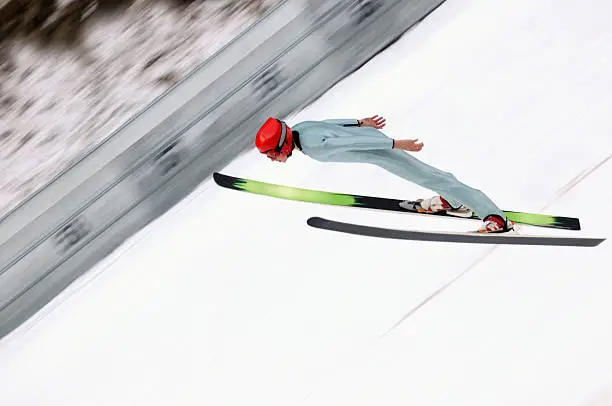 Young male ski jumper landing. ski jump K=110m