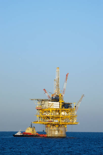 istock Off shore production platform with supply vessels. Oil rig 157327389