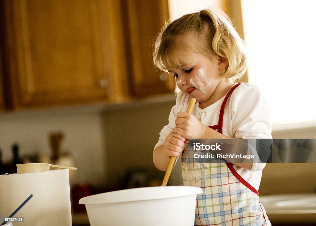 Making Cookies A young girl makes cookies. Domestic Room Stock Photo