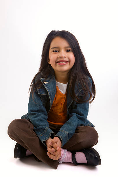 Adorable Elementary Age Girl Sitting Cross Legged, Mixed Asian Hispanic