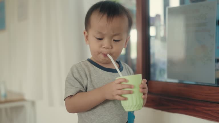 Happiness and Hydration: Asian Child Enjoying Fresh Water, a Moment of Pure Joy and Innocence.