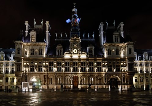 A night picture of the famous building Hotel de Ville in Paris.