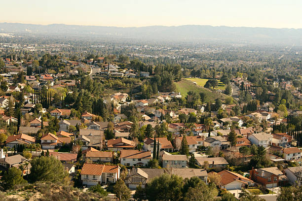 Tiled rooftops galore in the largest suburbs in USA, 'the valley' , San Fernando Valley, part of the city/county of Los Angeles, CA; Santa Monica Mtns in smoggy distance