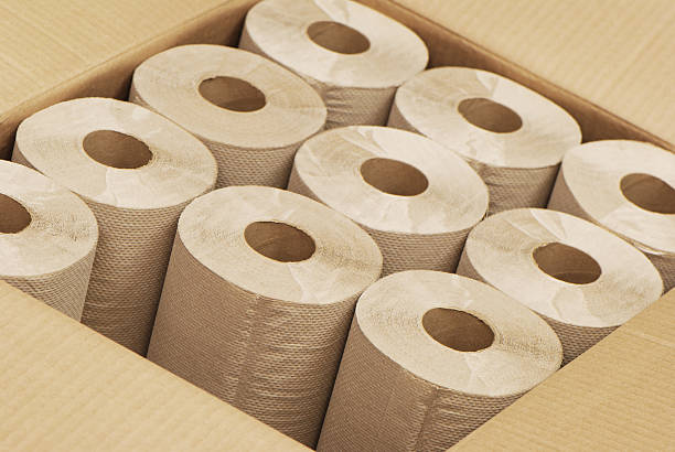 An open brown box of rolls of paper towels stock photo