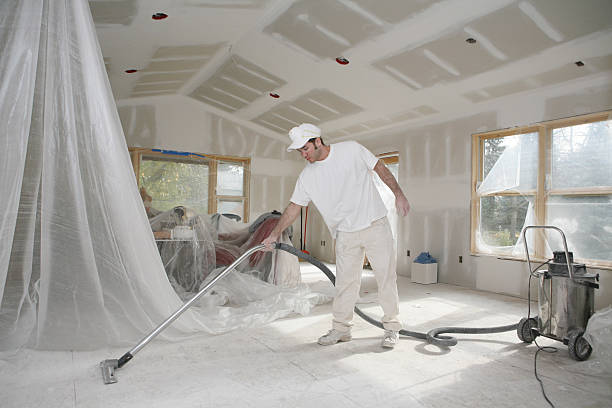 Taper Vacuuming Dust Home addition in the taping/sanding stage. construction cleaning stock pictures, royalty-free photos & images