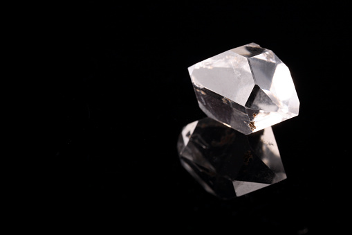 Dazzling diamond on black background with abstract lights