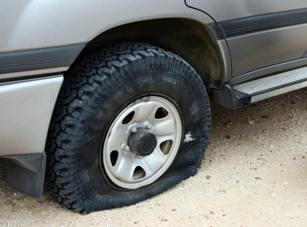 istock A flat tire deflating on an unpaved road 157328790
