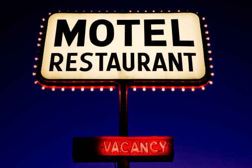 Motel Billboard Sign at twilight in the Desert Landscape, USA.
