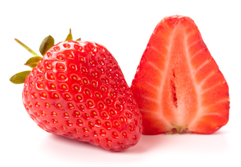 Fresh strawberries isolated on white background. Studio shot. Shallow DOF, selective focus on left strawberry. 