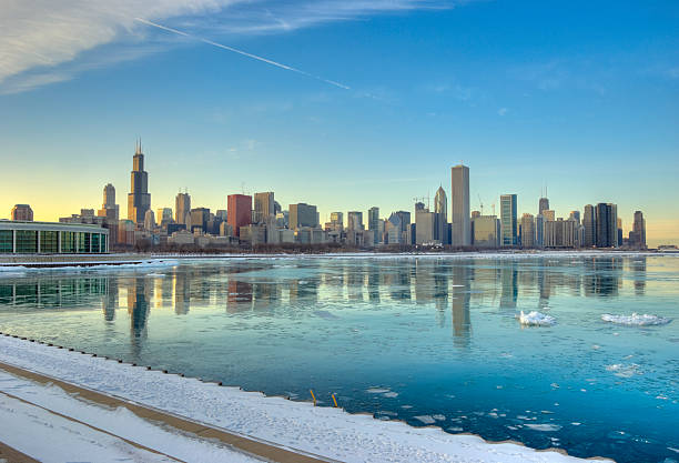 Winter View of the Chicago Skyline The Chicago skyline shortly before sunset on a cold winter day from across Lake Michigan. aon center chicago photos stock pictures, royalty-free photos & images