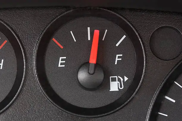 Photo of Black Fuel Gauge with Red Marker Over Half Full