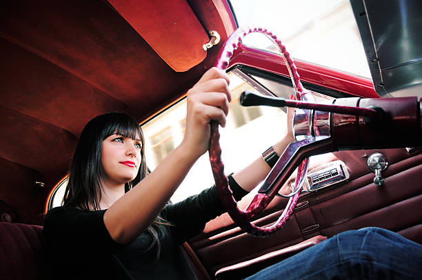 istock Young woman in an old fashioned car 157329296