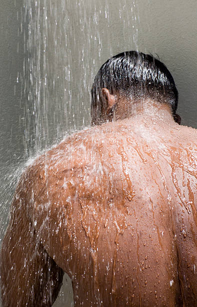 alfresco showering male nude stock photo