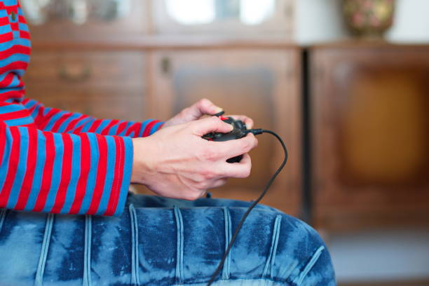 istock Woman playing video games 1573296419