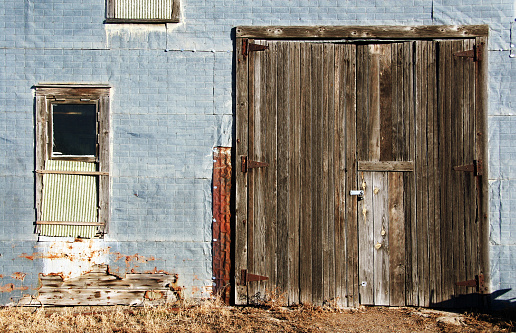 Dilapidated (but beautiful) old tin-sided garage with wooden door