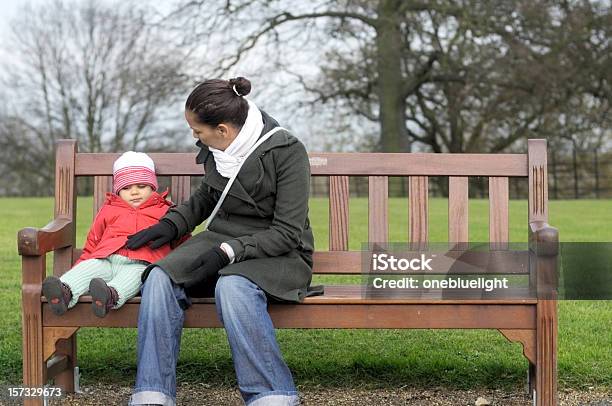 젊은 구슬눈꼬리 자신의 아기 소녀 벤치 공원 벤치에 대한 스톡 사진 및 기타 이미지 - 공원 벤치, 앉음, 여자
