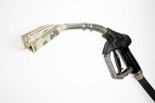 Pump nozzle sucking dollars Pump nozzle sucking dollars fuel prices photos stock pictures, royalty-free photos & images