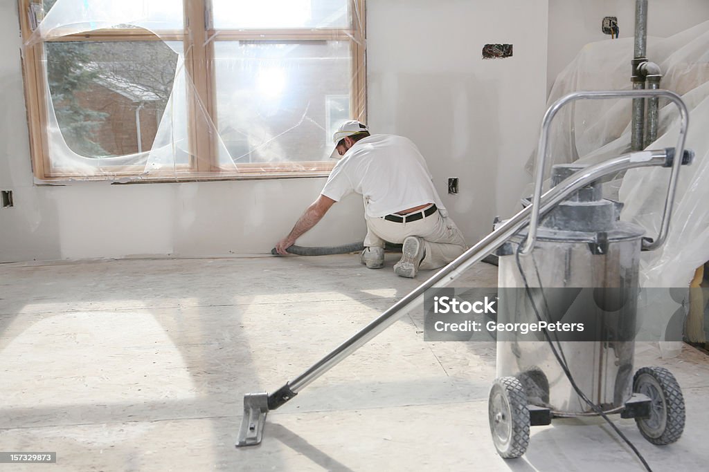 Taper Vacuuming Dust Home addition in the taping/sanding stage. Cleaning Stock Photo