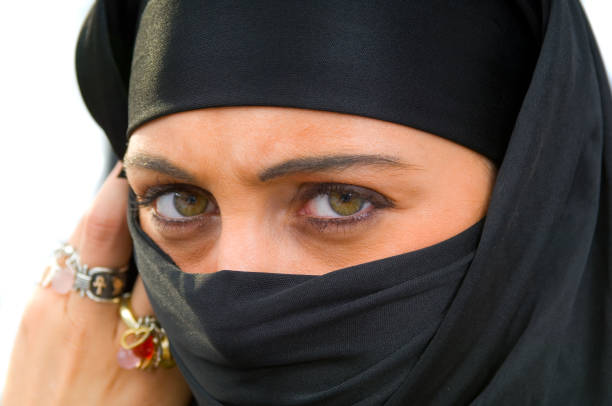 Beautiful muslim teenage girl posing on black background (this picture has been taken with a Hasselblad H3D II 31 megapixels camera)