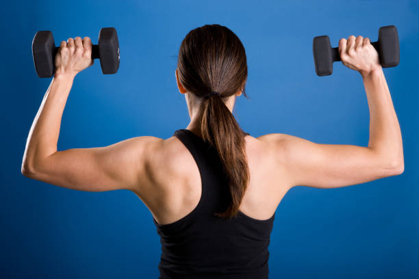 Fitness-Female Lifting Weights-Rear View