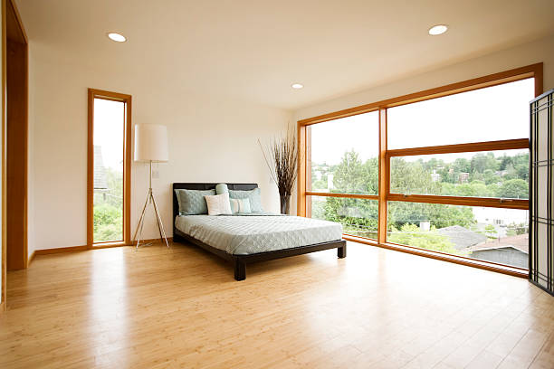 Modern Spacious Bedroom with Hardwood Floors stock photo