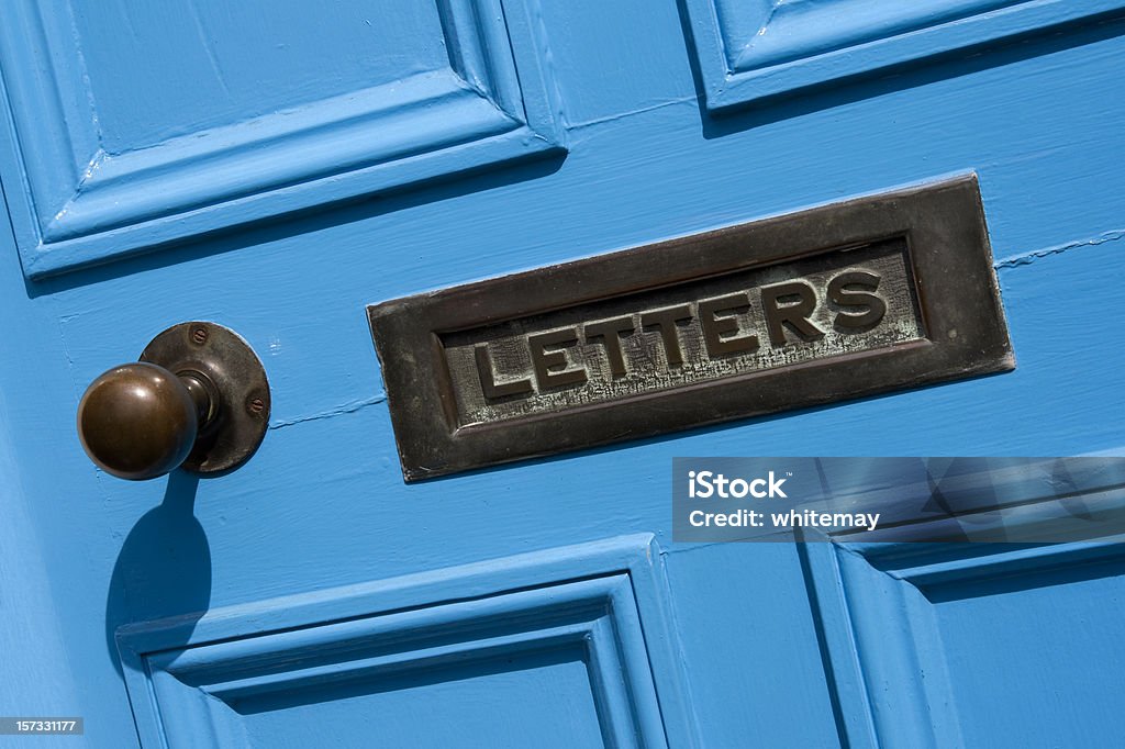 Blue door and letterbox Close up of a bright blue door with an aged metal letterbox. Door Stock Photo