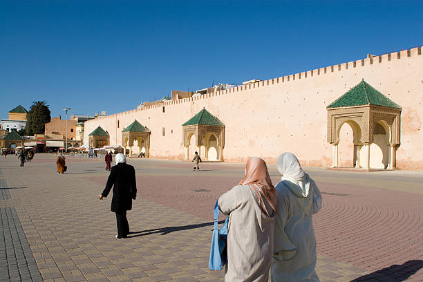 Fez, Morocco: A decorative minaret towers over the surrounding rooftops of Fez’s old Medina. The scene captures the historic Al Karaouine Mosque and University woven into everyday city life.